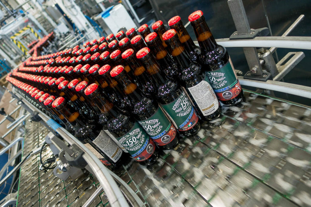 Bottles of Yukon Brewing's Swift Currant Dark Ale roll off the production line at Central City in Surrey.