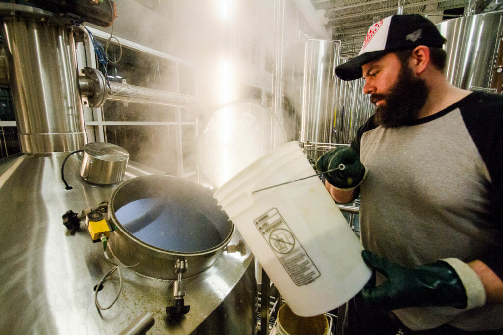 Chris Long of PEI Brewing gets hands on with Central City's brewhouse.