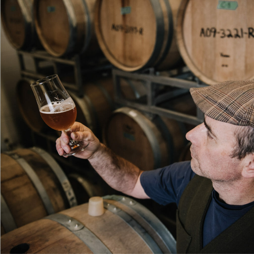 Iain Hill in the barrel room at Strange Fellows, photo credit Olga Zwart