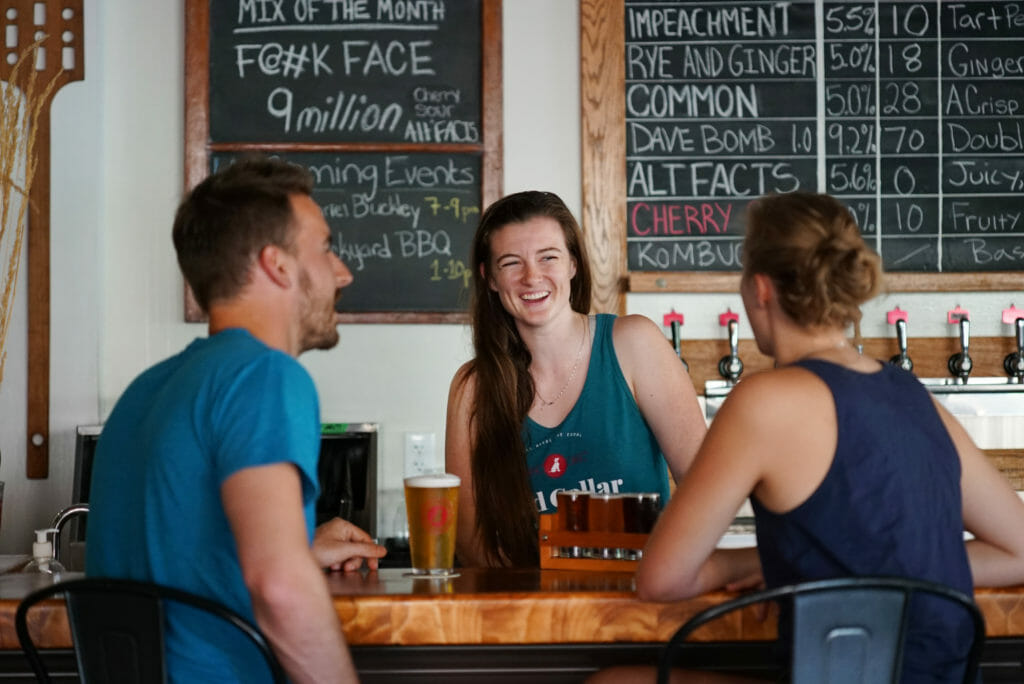 Lara talking to customers about their beers