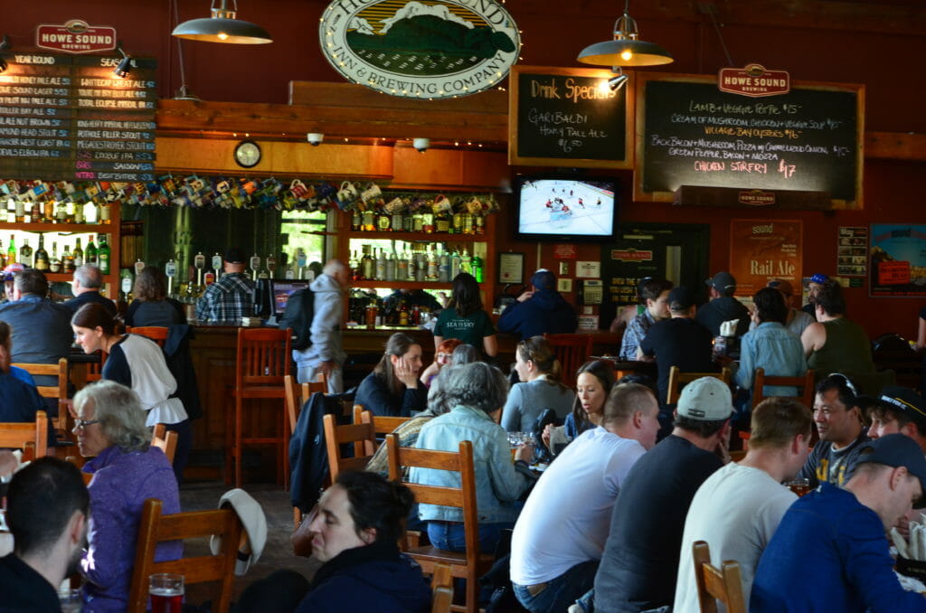 people enjoying beers at Howe Sound Brewing in Squamish