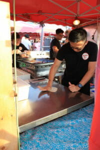 image of man making roti at Richmond Night Market