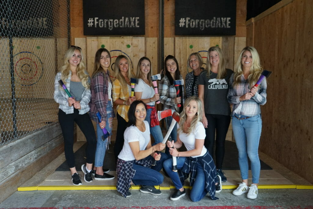 group of women wearing plaid and swinging axes at Forged Axe Throwing in Whistler, BC