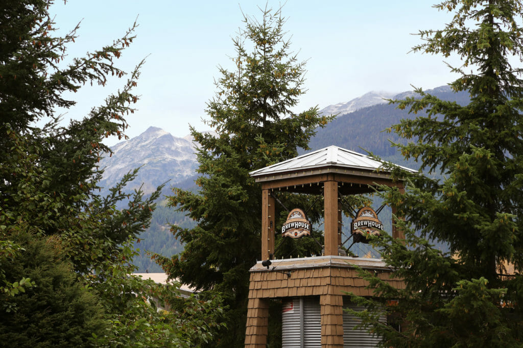 The Brewhouse tower in Whistler Village, with the mountains in the background