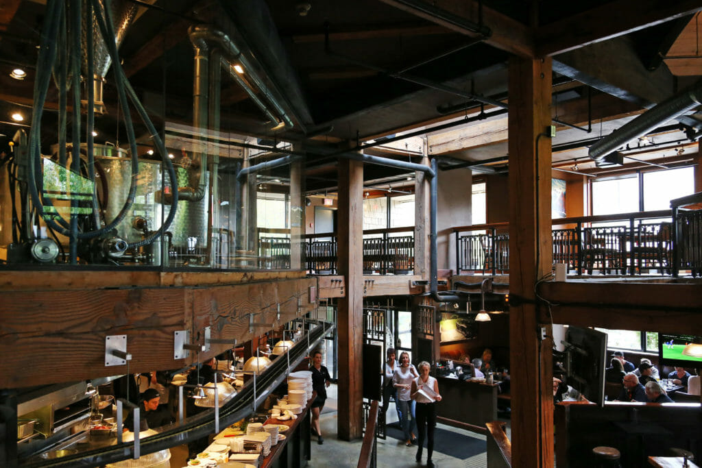 Whistler Village's Brewhouse space, with plenty of seating and the brewing system on the upper floor