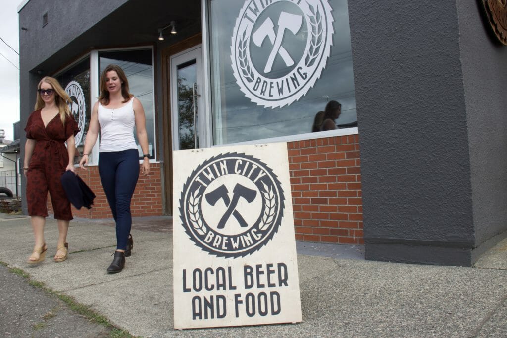 two women walking out of Twin City Brewing in Port Alberni