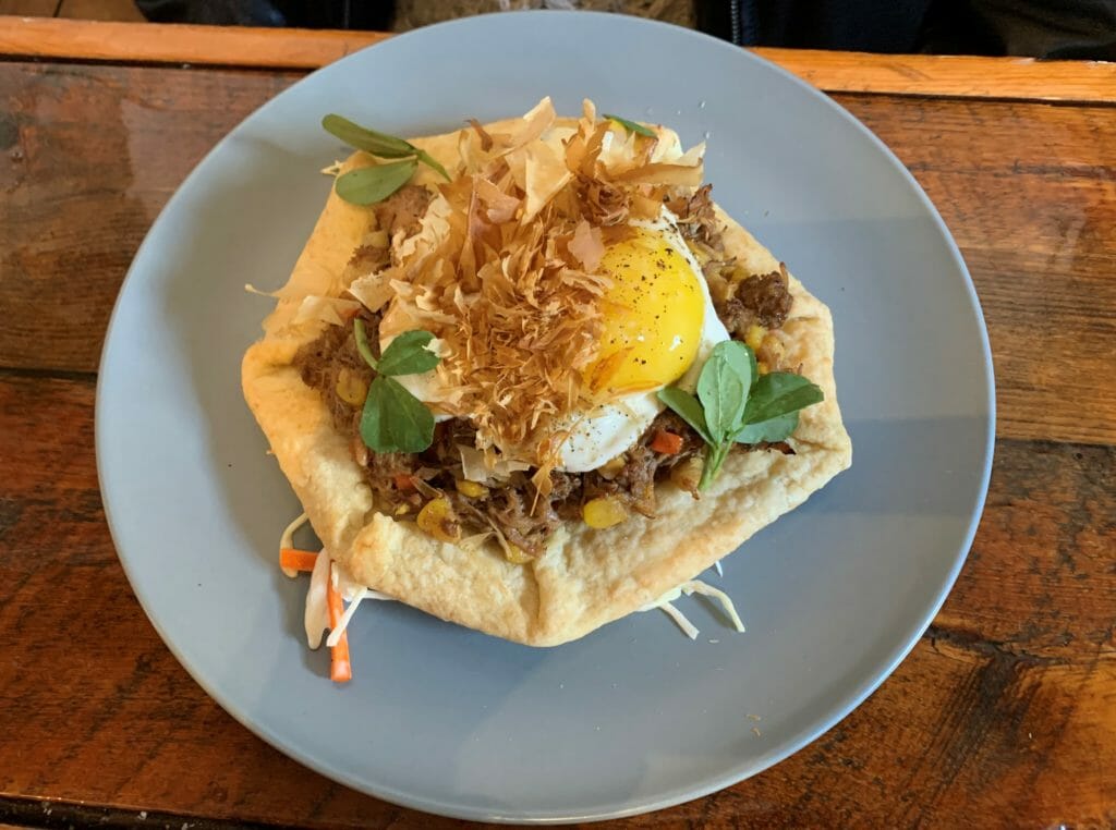 photo of Provisions Kitchen hoisin pork and vegetable meat pie dish with a fried egg on top