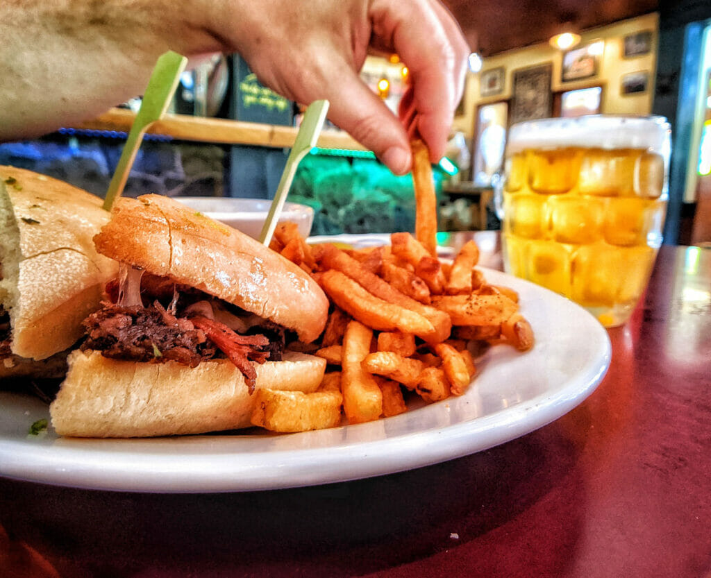 Pulled pork and fries with mug of beer at pub