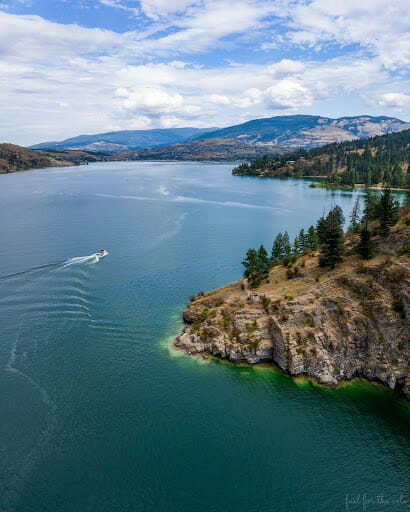 Photo of a boat on the water near Turtle Heads Point at Kalamalka Lake Provincial Park near Vernon, BC.