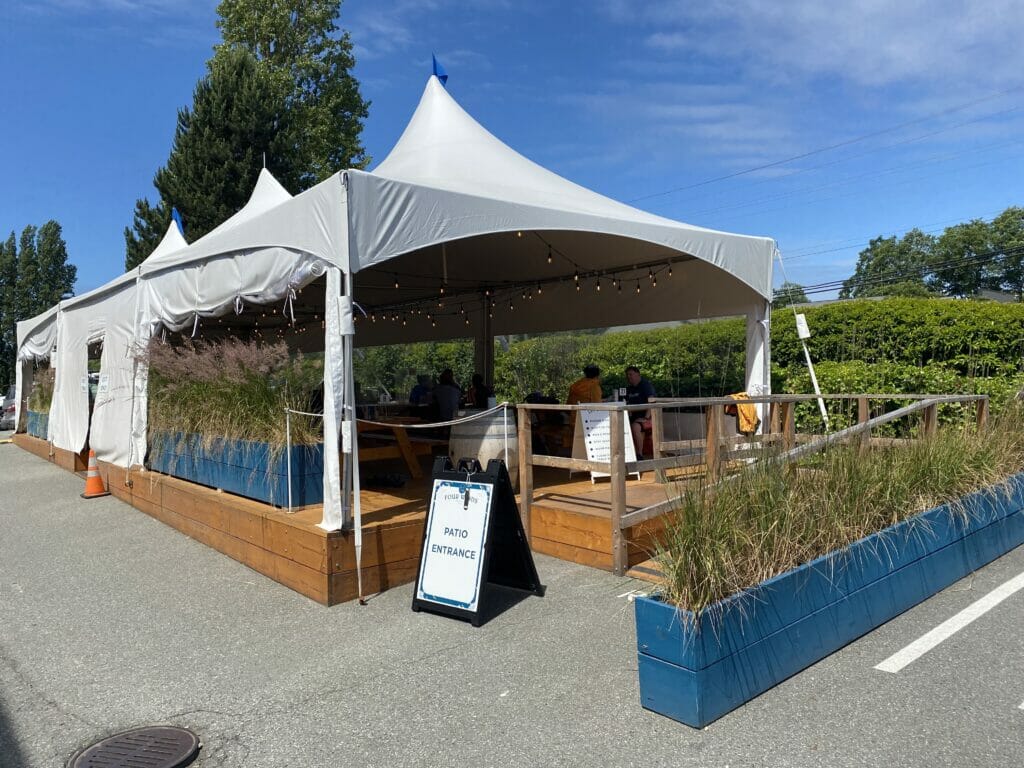  cycling between breweries in delta -Four Winds Brewing tent - BC Ale Trail