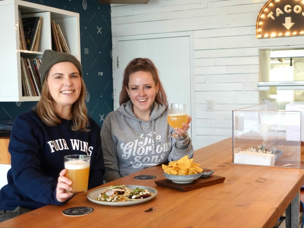 Ashley in Four Winds Tasting Room with friend/coworker Bailey, BC Ale Trail