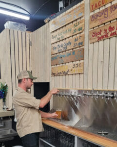 Jonah at Denotate Brewing pouring a pint