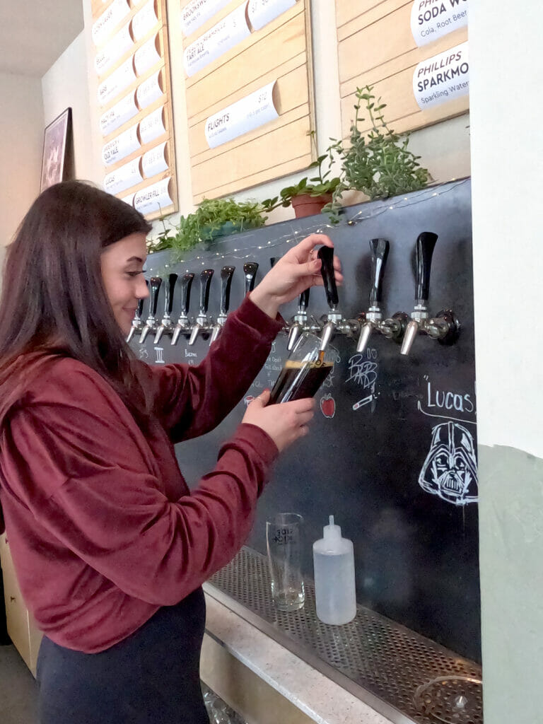 Pouring a pint at Sidekick Brewing