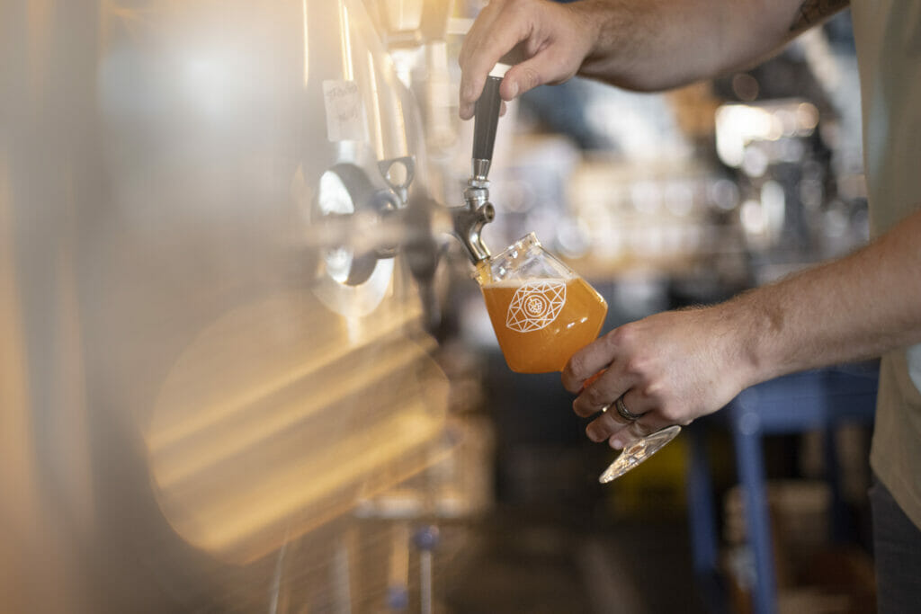 pouring a pint from the serving tanks at Bright Eye Brewing in Kamloops BC