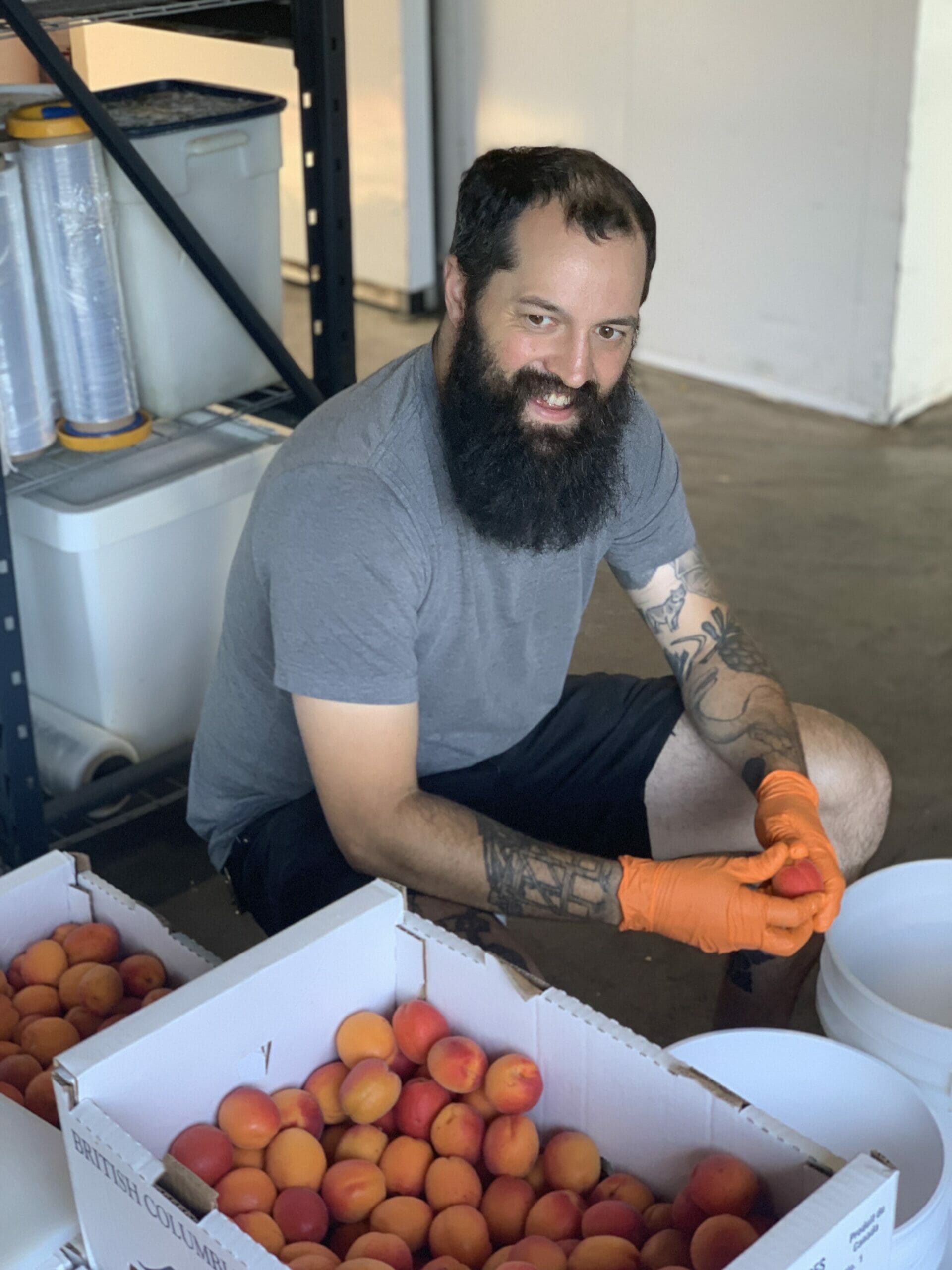 Azlan Graves pitting apricots for his next brew at Main St. Brewing, Vancouver, BC