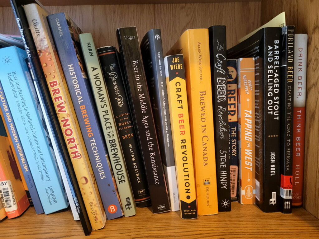 a shelf of beer-themed books