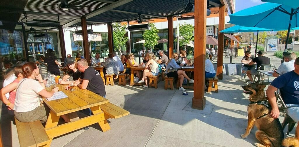 A bustling, sunny patio at Shore Line Brewing in Kelowna, BC