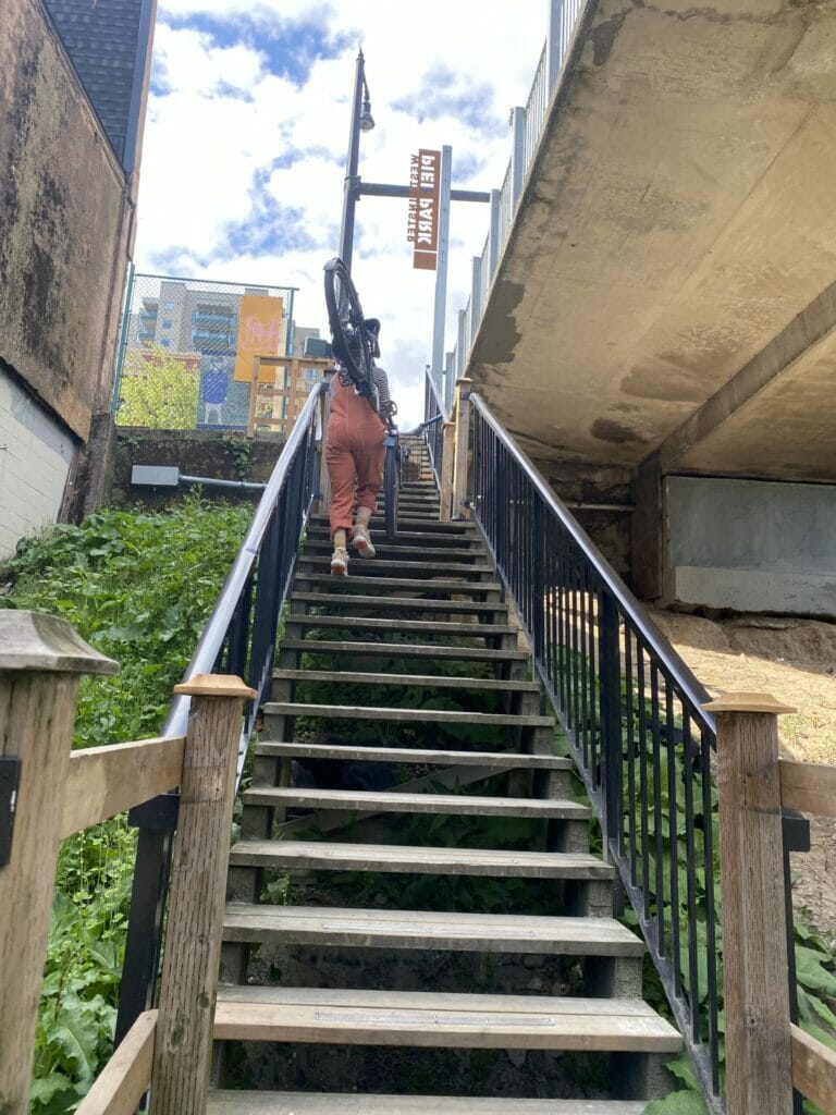 Carrying a bike up a set of stairs in New Westminster, BC