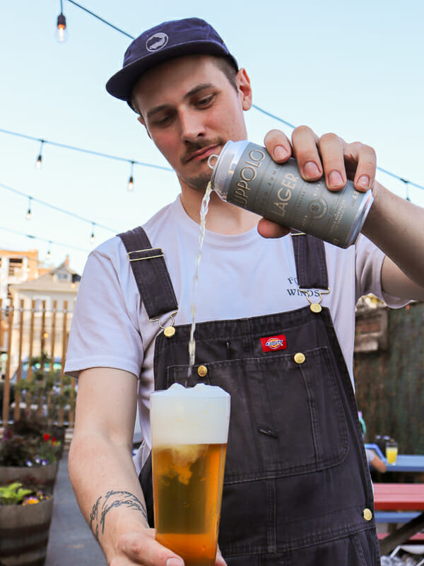 Connor Blanchard from Luppolo Brewing pouring a Poco Fumo Smoked Helles Lager
