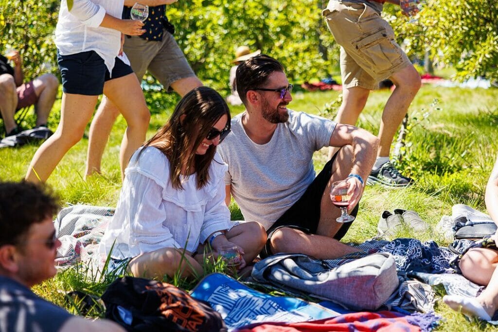 A couple on their picnic blanket enjoying Farmhouse Fest at UBC Farm