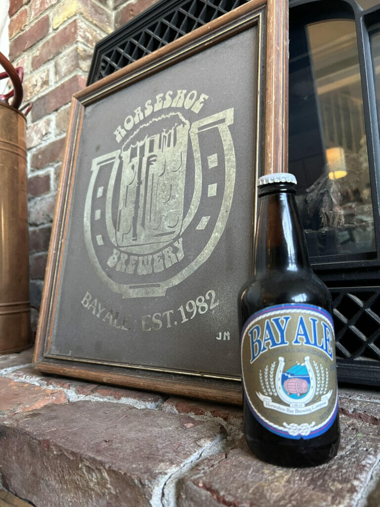 Horseshoe Bay Brewery mirror made by John Mitchell and an unopened bottle of Bay Ale (photo: David Bruce-Thomas)