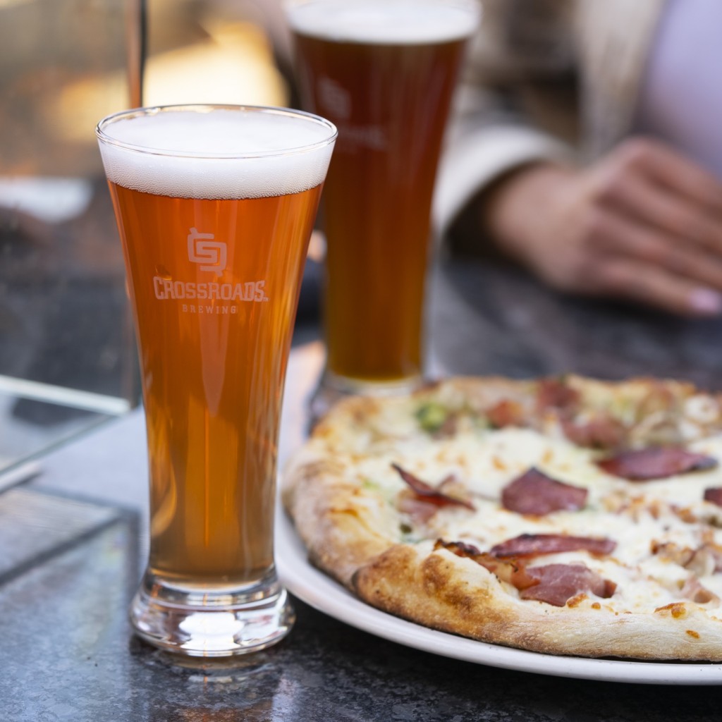 A pint of craft beer and pizza at CrossRoads Brewing & Distilling in Prince George, BC