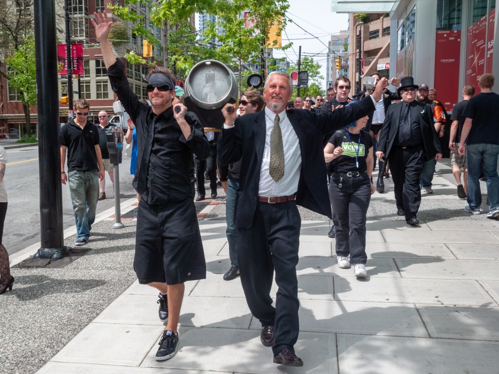 Mark Andrewsky and Tony Dewald carry a caskon a bier down the sidewalk in Vancouver during Vancouver Craft Beer Week in 2010