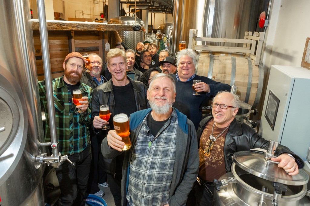 Tony Dewald smiling among a group of friends at Brassneck Brewing - Brian K. Smith